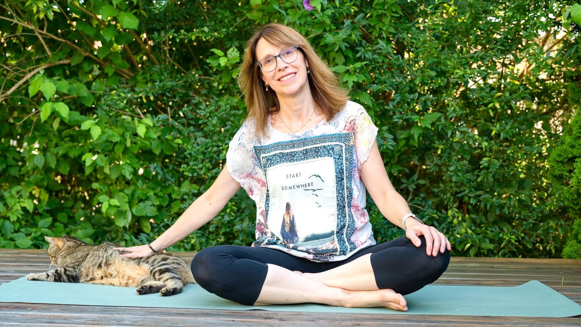 Yoga Weißenhorn: vom vollen Kopf zur inneren Klarheit Elisabeth Blässing Yogalehrerin im Schneidersitz mit Katze